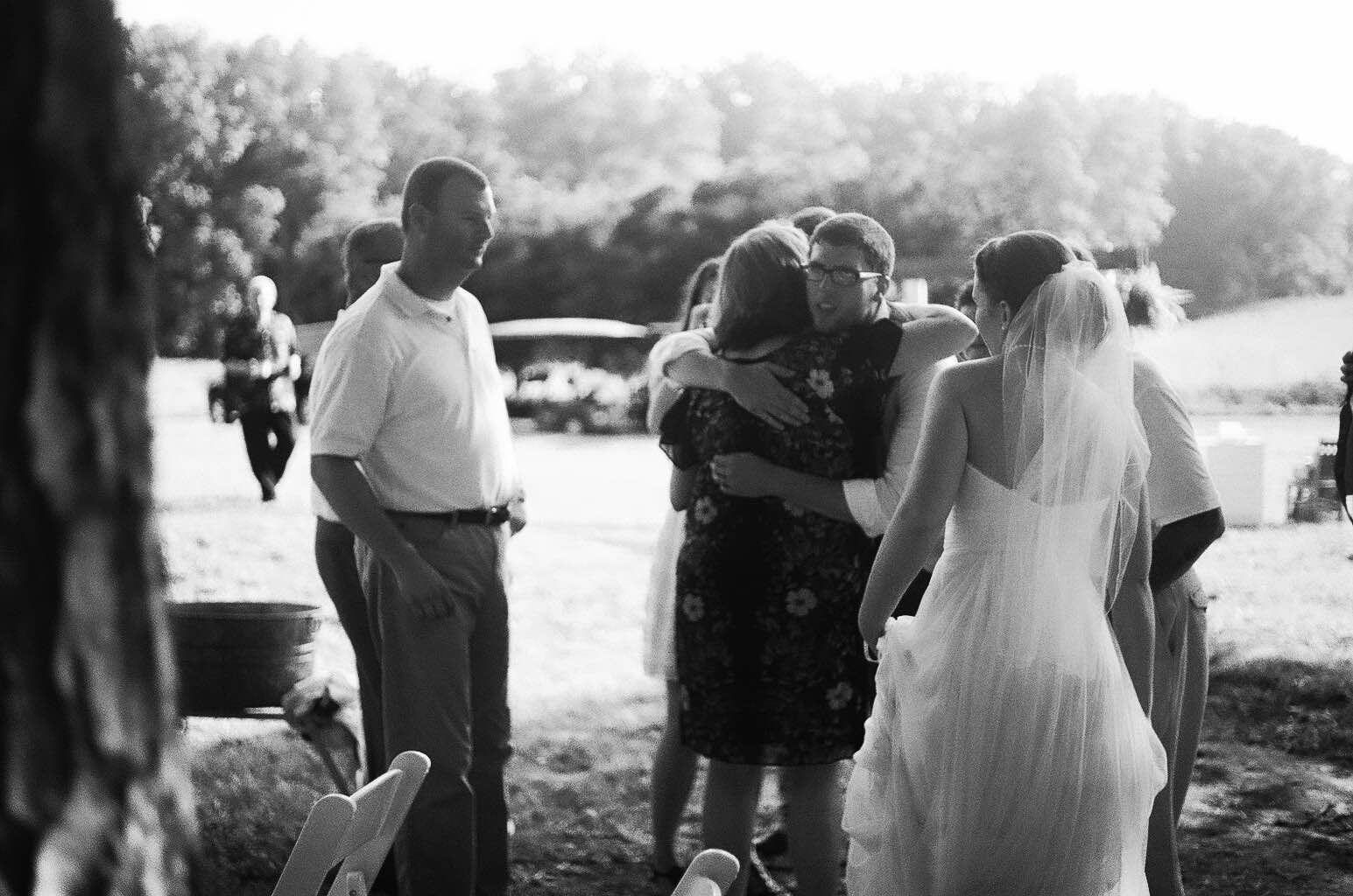 Bride hugging guests during wedding