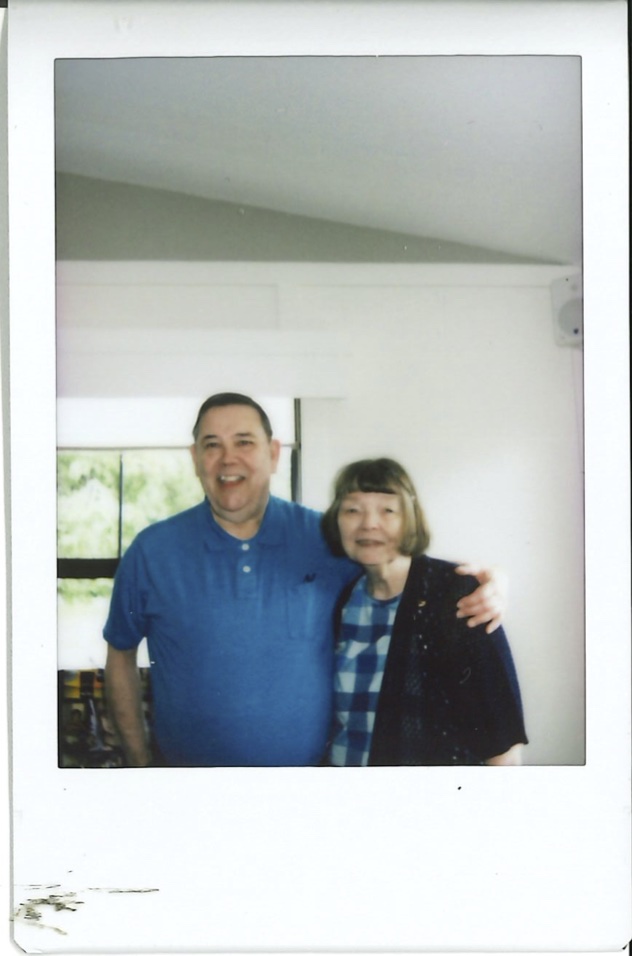 Instax of couple at a party in front of a window